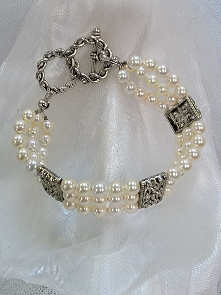 This multi strand Swarovski pearl bracelet is the perfect accent to any wedding gown. There is a silver toggle clasp with two possible circles for adjustments. This bracelet is elegant, it can be customized and matching accessories can be made. Comes gift boxed. USA made by women owned and staffed small business Elegant Multi-strand Wedding Jewelry, Elegant Round Beads Bracelets For Anniversary, Elegant Pearl Bracelet With Pearl Drop For Anniversary, Elegant Adjustable Jewelry For Anniversary, Elegant White Gold Pearl Bracelet For Anniversary, Elegant Adjustable Pearl Bracelet For Formal Occasions, Formal Pearl Embellished Bracelet Jewelry, Adjustable Pearl Bracelet For Formal Events, Classic Multi-strand Jewelry For Weddings