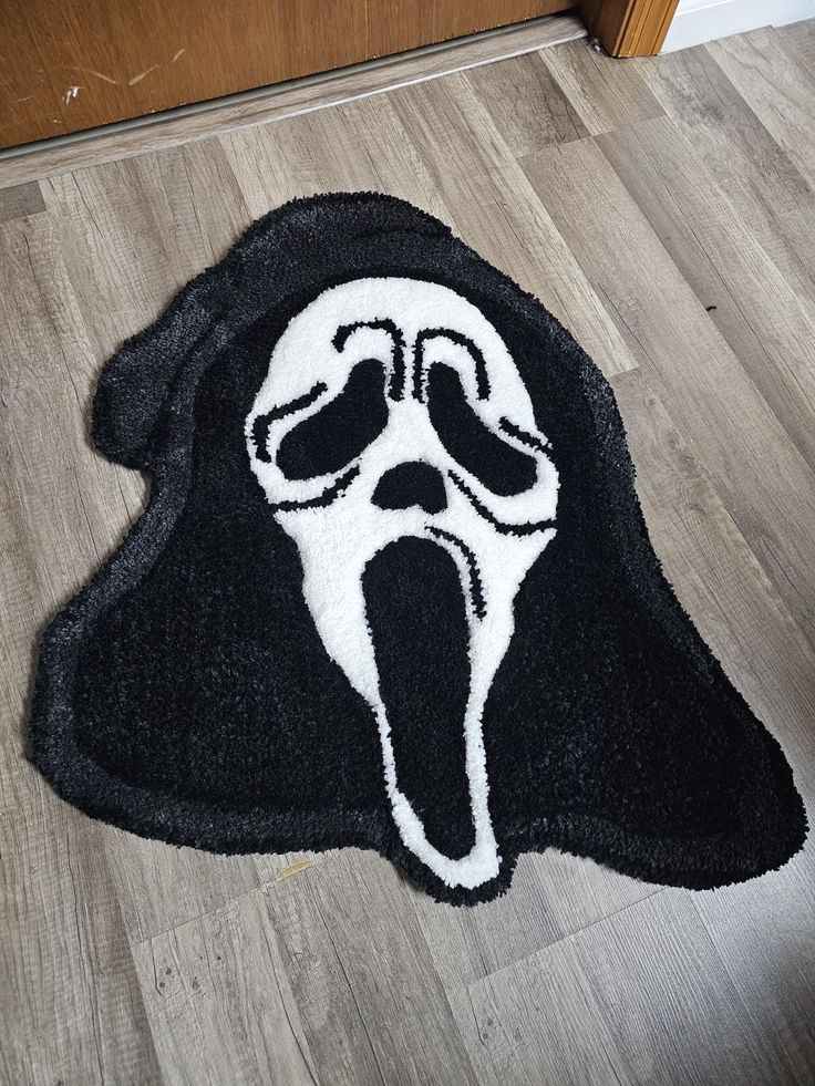 a black and white rug with a ghost face on it