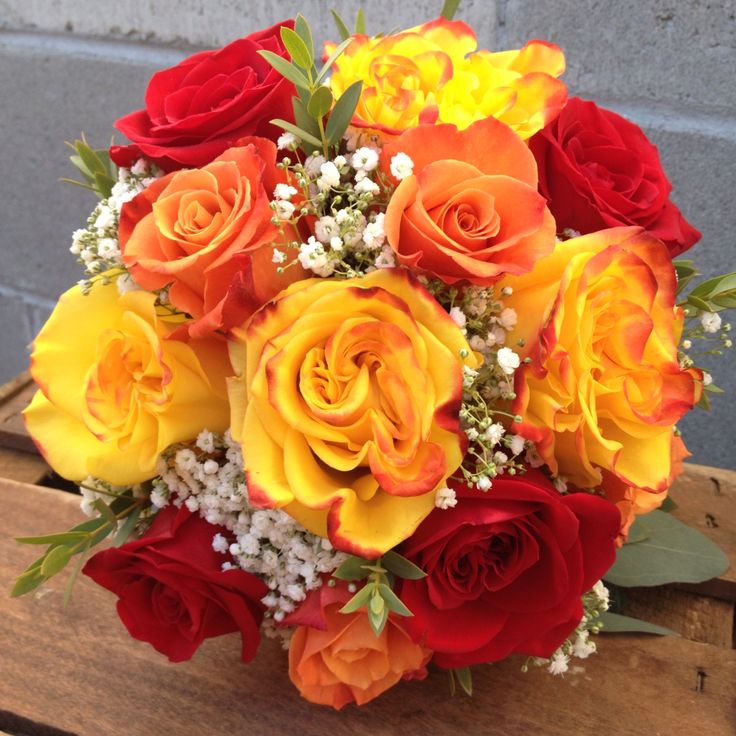 a bouquet of flowers sitting on top of a wooden box