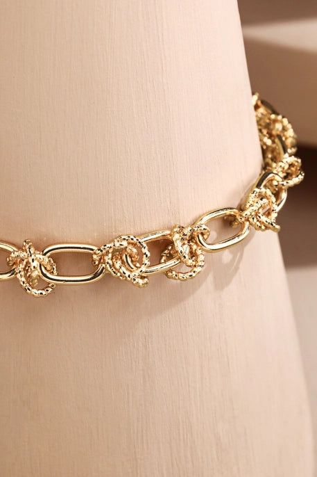 This knotted chain link bracelet is a versatile and stylish addition to any jewelry collection. With its unique design and durable construction, it can be worn for any occasion. Made with high-quality materials and a lobster clasp closure this bracelet will add an elegant touch to any outfit. Nickle and Lead compliant Approx. 7" L + 2" extender Diameter 2 1/4" Elegant Link Jewelry, Elegant Link Fashion Jewelry, Metal Chain Bracelet With Lobster Clasp As Fashion Accessory, Elegant Chain Bracelet With Lobster Clasp, Chic Chain Link Bracelet With Lobster Clasp, Trendy Metal Link Charm Bracelet, Chic Metal Paperclip Bracelet With Adjustable Chain, Chic Adjustable Paperclip Chain Bracelet, Chic Metal Paperclip Chain Bracelet