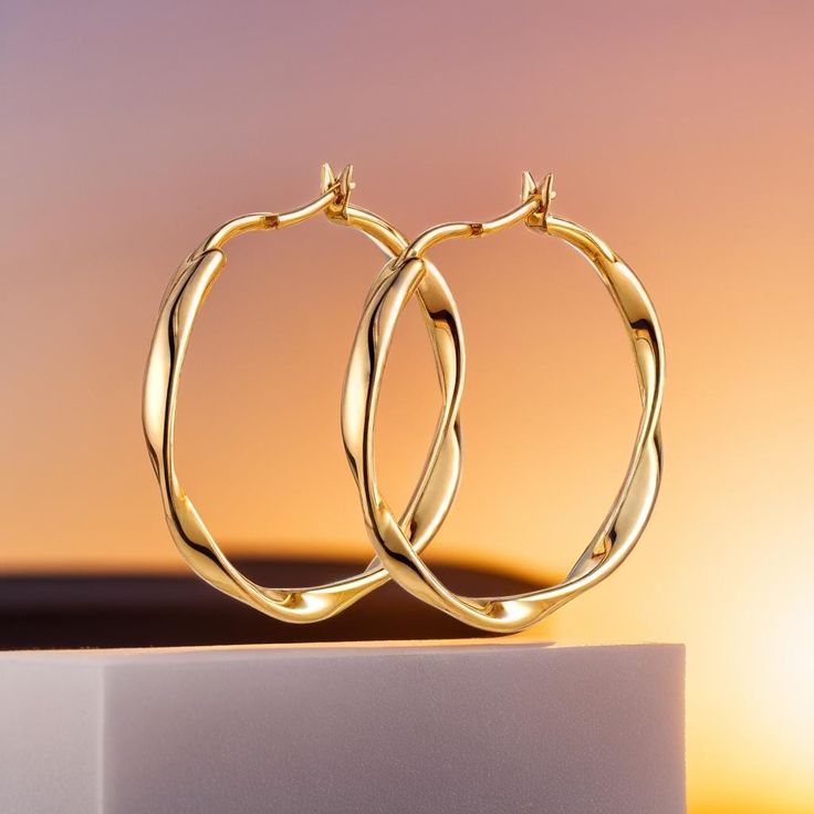 Add a touch of elegance to her style with our Gold Twisted Hoop Earrings, crafted from high-quality stainless steel for durability and shine. These large hoops feature a unique twisted design that exudes boho charm, making them perfect for a bridal look or everyday wear. Their classic gold finish and modern twist make them versatile enough to complement any outfit, from casual to formal. Ideal as a gift for her, these earrings combine style, quality, and comfort, making them a timeless addition Modern Twist Yellow Gold Hoop Earrings For Everyday, Elegant Twisted Gold Plated Hoop Earrings, Twisted Gold Plated Yellow Gold Hoop Earrings, Twisted Gold Plated Hoop Earrings, Twisted Yellow Gold Hoop Earrings, Tarnish Resistant, Boho Bridal Jewelry, Twisted Hoop Earrings, Charm Making, Bridal Look