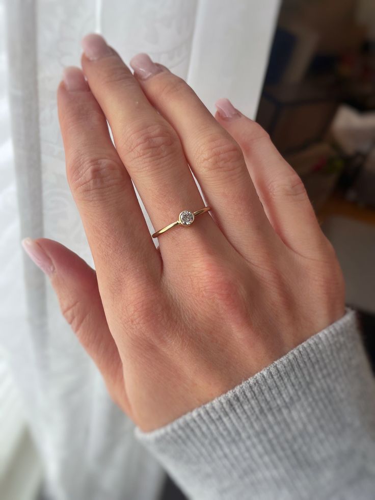 A delicate 14k Gold Filled ring featuring a sparkly and beautiful cubic zirconia diamond. The stone is 4mm in size. Great as an everyday ring, promise ring or to stack with others! Listing is for single (1) ring only.   Details: 14k Gold Filled 5A Cubic Zirconia diamond, 4mm in size Fits true to size Handmade jewelry, free from lead and nickel Shop all rings here! https://www.etsy.com/ca/shop/StarsAlignJewelry?ref=simple-shop-header-name&listing_id=684482651&section_id=26258580 If for any reason Delicate Open Diamond Ring With Brilliant Cut, Delicate Rings With Diamond Accents And Round Cut, Dainty Diamond White Ring With Diamond Accents, White Diamond Ring With Diamond Accents In Dainty Style, Delicate Round Cut Rings With Diamond Accents, White Dainty Diamond Ring With Accents, Dainty White Diamond Ring With Accents, Delicate Cubic Zirconia Ring With Diamond Accents, Delicate Diamond White Rings With Prong Setting