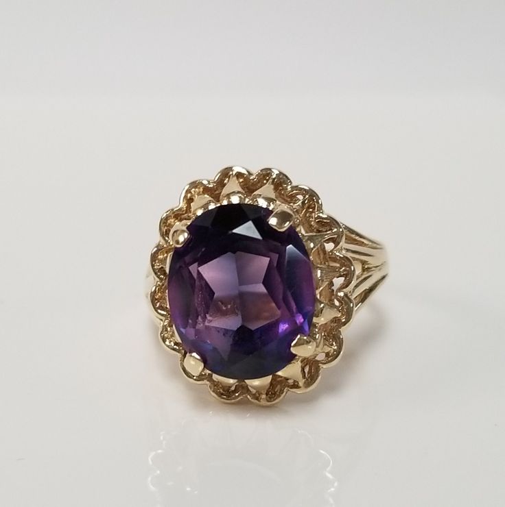 "Thanks for shopping our vintage estate store. We tend to sell well below wholesale and truly hope you enjoy all of our items. Many of the items are one of a kind, so please enjoy scrolling through the pictures and hopefully something will catch your eye. Brown spots are from camera or reflections. Estate 10k yellow gold purple blue 5ct sapphire cocktail filigree ring. Gem is testing natural, more than likely created, beautiful gem. Ring size: 5.5 Setting: 12mm 5/8\" Gem: 10mm by 12mm 5cts Band Estate Oval Jewelry For Gifts, Vintage Gold Amethyst Birthstone Ring, Vintage Oval Amethyst Birthstone Ring, Vintage Oval Birthstone Ring Collectible, Vintage Oval Birthstone Ring As A Collectible, Vintage Oval Amethyst Ring With Filigree, Antique Oval Birthstone Ring Collectible, Antique Oval Birthstone Collectible Ring, Estate Style Rings With Center Stone As Gift