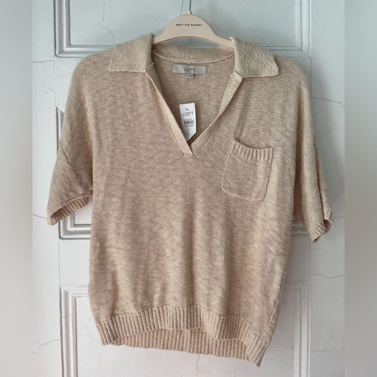 Nwt Loft Short-Sleeved Sweater Super Soft Collar And Front Pocket Size S, But Would Fit A S Or M Nicely Never Worn, Excellent Condition Beige Cotton V-neck Knit Top, Knitted V-neck Top For Work, Cream Textured Knit V-neck Top, Knitted Short Sleeve Tops For Fall, Cozy Knit Tops For Work, Cozy Collared Tops For Spring, V-neck Knitted Workwear Tops, Cozy Collared Top For Workwear, Casual Knitted Tops For Work