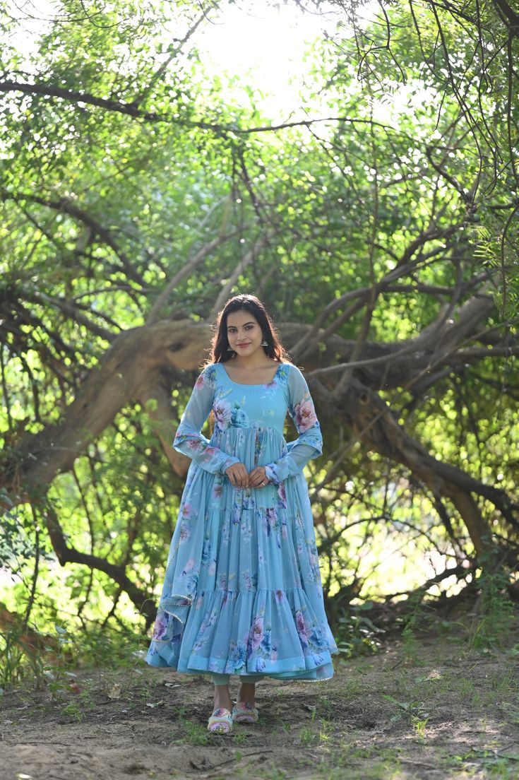 PRODUCT DESCRIPTION :-Presenting Sky floral Printed chiffon tiered pattern Anarkali with matching Chiffon dupatta and cotton Pants . The flare of the Anarkali and Most comfortable fit will fill your heart with Immense Joy . Anarkali :- Chiffon Pant :- CottonDupatta :- ChiffonClosure Used:- Side zipColor:- SkyCare Instructions :- Dry clean onlyModel Size :- Model is wearing XS sizeModel Height :- 5.6''DISCLAIMER :- Slight color variations may occur due to different screen resolution. Bohemian Anarkali Set In Georgette With Floral Print, Bohemian Anarkali Set With Floral Print In Georgette, Bohemian Georgette Anarkali Set With Floral Print, Bohemian Floral Print Maxi Anarkali Set, Eid Anarkali Set With Ruffles, Anarkali Georgette Palazzo Set With Ruffles, Bohemian Floor-length Georgette Sharara, Navratri Anarkali Set With Ruffles, Bohemian Georgette Maxi Sets