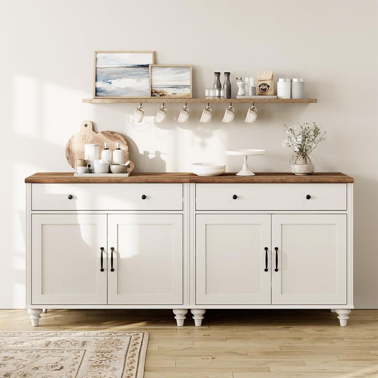 a kitchen with white cabinets and wooden counter tops on top of a hard wood floor