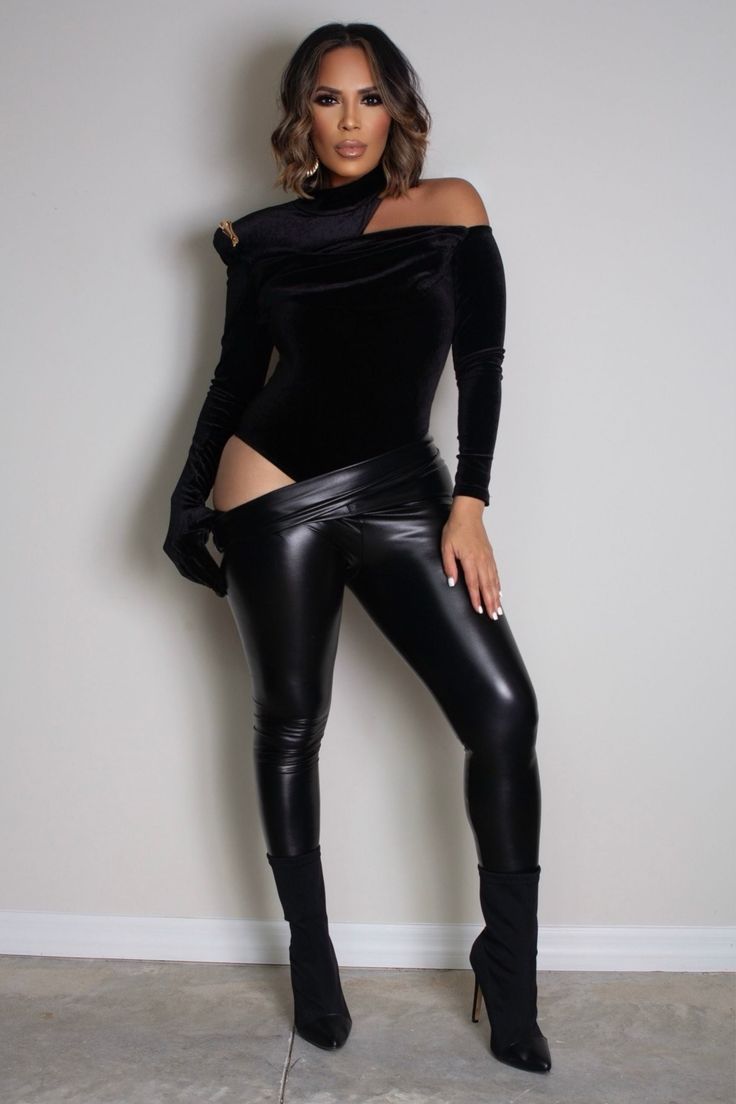 Turn heads this autumn and winter with our Asymmetrical Neck Cut Out Shoulder Velvet Bodysuit. This striking black bodysuit features a bold asymmetrical neckline with an alluring cut-out detail, complemented by a stand collar and thick shoulder pads for added drama. The ruched accents and decorative chain enhance its sophisticated design, while one sleeve includes an attached glove for an extra edge. Made from slightly stretchy knitted fabric, this slim-fit bodysuit ensures a sleek silhouette an Chic Stretch Bodysuit With Asymmetrical Neckline, Elegant Stretch Bodysuit With Asymmetrical Neckline, Black Bodysuit With Asymmetrical Neckline For Party, Black Party Bodysuit With Asymmetrical Neckline, Fitted Bodysuit With Asymmetrical Neckline For Night Out, Fitted Bodysuit With Asymmetrical Neckline For Evening, Black Fitted Bodysuit With Asymmetrical Neckline, Chic Bodysuit With Asymmetrical Neckline For Night Out, Asymmetrical Stretch Bodysuit For Night Out