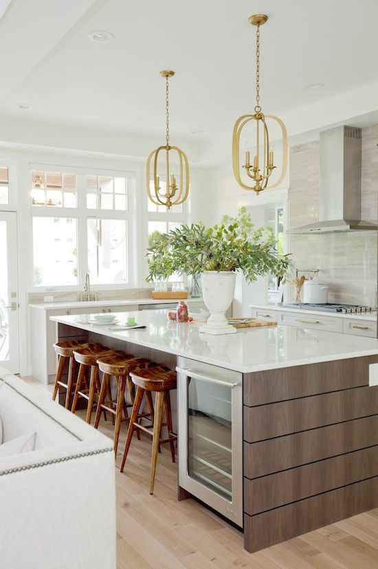 a kitchen island with stools in front of it