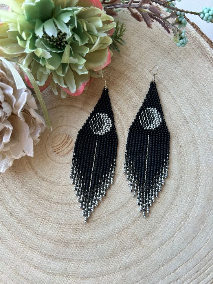 These long earrings with fringe and a moon ornament made of black beads embody elegance and mystery. Made from Czech beads. Length 4.8 inches(12cm). Width 1.2 inches(3cm). Hypoallergenic clasp. If you want these earrings in a different color, write to me and I will be happy to make them for you. Moon Fringe Earrings, Bohemian Black Tassel Earrings With Round Beads, Black Bohemian Tassel Earrings With Round Beads, Handmade Black Moon Earrings, Handmade Black Moon-shaped Earrings, Handmade Black Crescent Earrings, Black Beaded Tassel Earrings With Round Beads, Handmade Black Beaded Long Drop Earrings, Black Beaded Long Drop Earrings