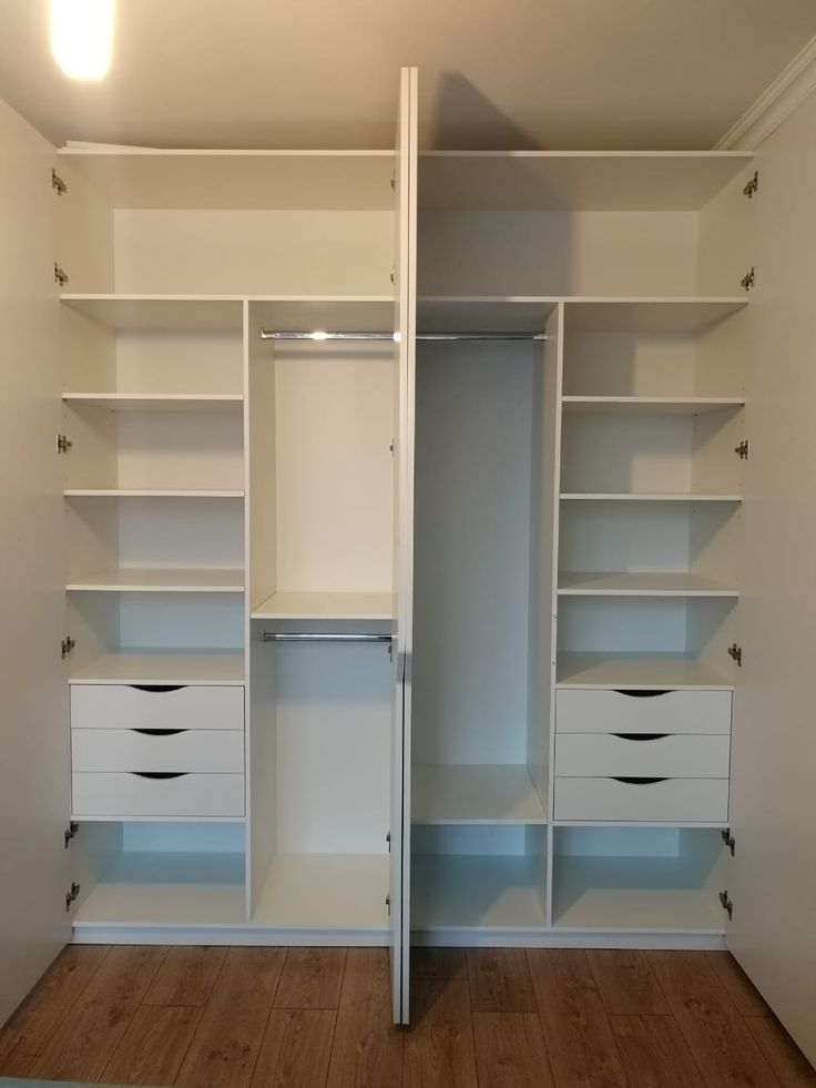 an empty white closet with drawers and shelves