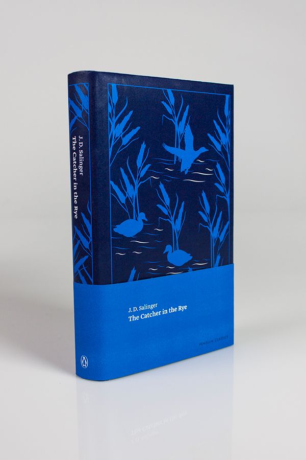 a blue book with an image of birds in the water on it's cover