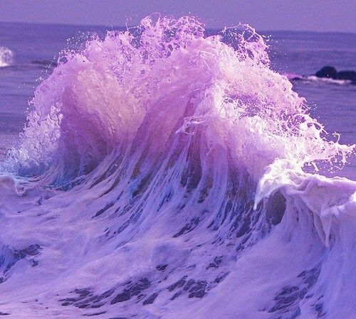 an ocean wave with pink and purple colors