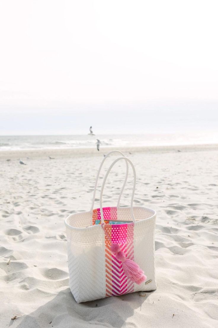 Venture boldly. Bags for making bold moves. These bags are colorful, hand-woven Mexican baskets that bring a bright, authentic style to any occasion. This bag is one of our biggest bags. Playera means "beach" in Spanish and this bag is perfect for beach/pool days. Large enough told hold 4 rolled towels, water bottle, book, phone and more! Our bags are made with durable plastic that lasts a lifetime. Care Instructions: Wipe the bag with a damp cloth and mild soap to remove dirt or stains. You can Beach Bag With Braided Handles, Multicolor Handwoven Bucket Bag For Summer, Summer Handwoven Multicolor Bucket Bag, Multicolor Summer Bucket Beach Bag, Multicolor Bucket Beach Bag For Vacation, Multicolor Summer Beach Bucket Bag, Rectangular Beach Bag For Poolside, White Crochet Basket Bag For Shopping, Multicolor Beach Bag With Braided Handles