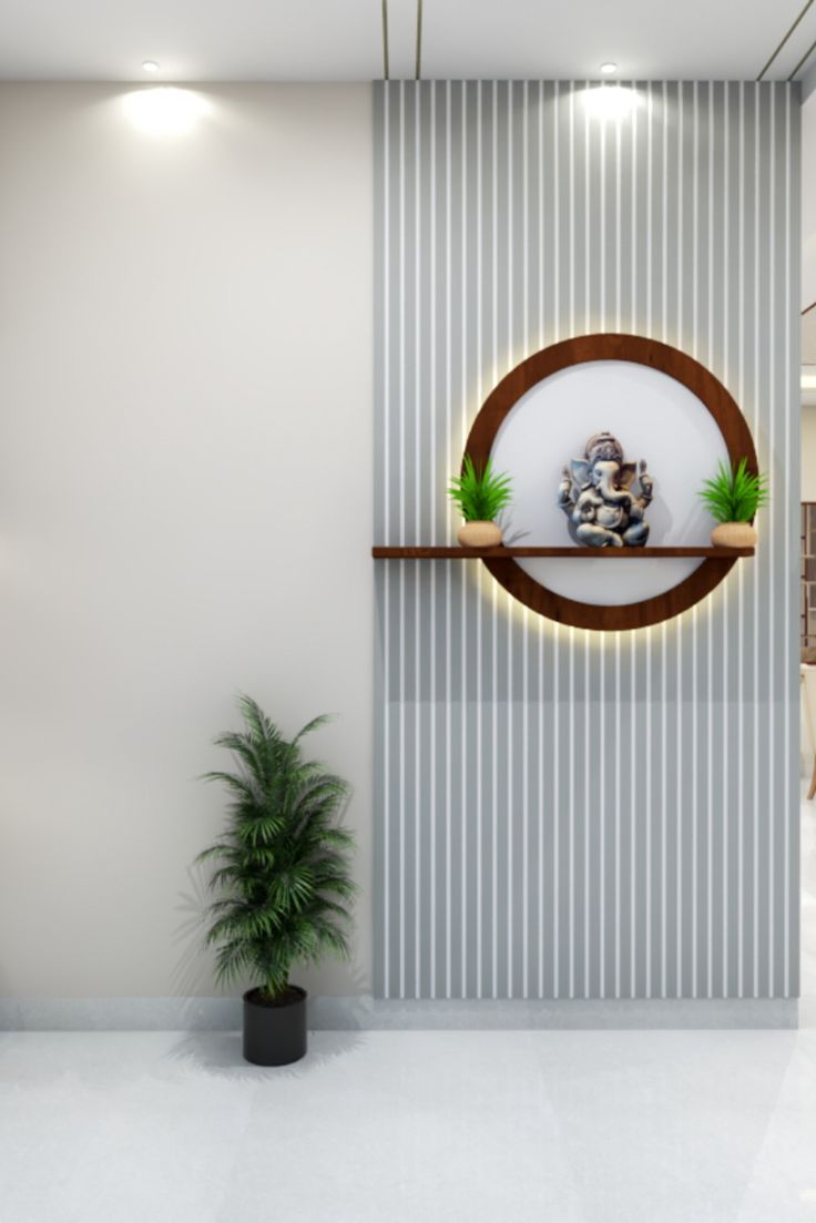 an empty room with a potted plant on the wall and a circular mirror above it