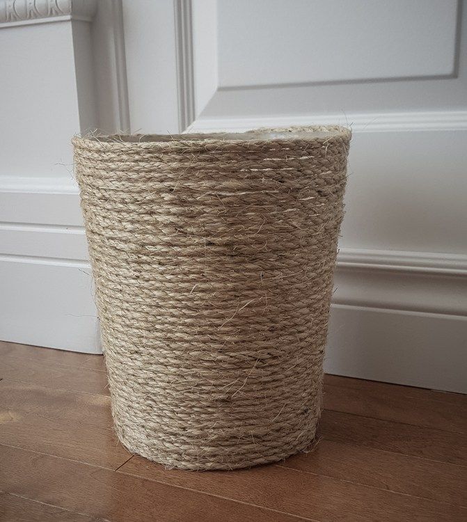 a large round rope basket on the floor