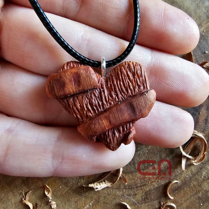 Pendant hand carved in Briar. This handmade wooden necklace is unique and is a perfect accessory if you love to wear something exclusive and it's suitable for special occasions.  This wooden pendant is a special gift for him and for her. The pendant comes with black cord of adjustable length.  If you have any questions about this article or any other information, or if you want to customize the pendant with initials, symbols or writings, send me a message and I will be more than happy to help yo Handmade Wooden Pendant Jewelry, Handmade Wooden Necklace Gift, Artisan Wooden Jewelry As A Gift, Artisan Wood Jewelry Gift, Artisan Necklace In Natural Wood As A Gift, Artisan Necklaces In Natural Wood As Gift, Unique Wooden Necklace For Gift, Engraved Natural Wood Necklace As Gift, Wooden Pendant Necklace For Gift