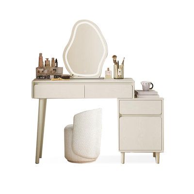 a white vanity table with a mirror, stool and other items on top of it