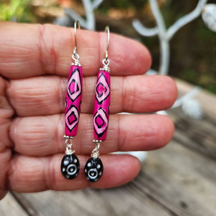 You probably heard me (wherever you are) shout out in delight when I discovered these hot pink bone beads Love the ethnic designs and of course the hot pink color.  I've added complimentary black Czech glass bead dangles.  EEEOOOWWWW Talk about statement earrings! And LIGHTWEIGHT too.   These gorgeous earrings are 2 1/4 inches in length, including the silver plated ear wire hooks.  Just over 1/4 inch wide.   Handmade. One of a kind design. Smoke free artist studio. Bohemian Teardrop Pink Earrings, Pink Teardrop Bohemian Jewelry, Bohemian Pink Teardrop Jewelry, Pink Bohemian Jewelry With Ear Wire, Pink Teardrop Earrings For Festival, Pink Teardrop Festival Earrings, Bohemian Pink Drop Earrings, Bohemian Pink Jewelry With Ear Wire, Pink Bohemian Drop Earrings