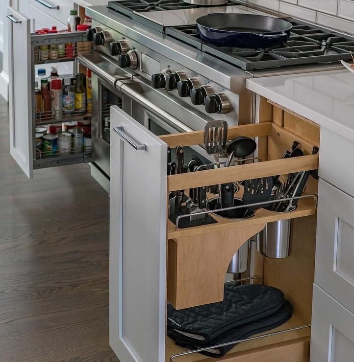 an open drawer in the middle of a kitchen