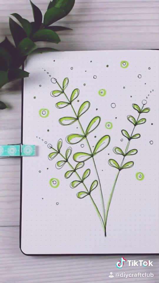 a notebook with some green plants on it