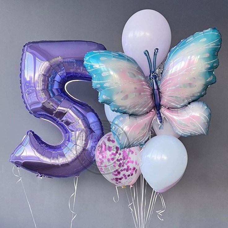 balloons and heliums are arranged in the shape of a butterfly