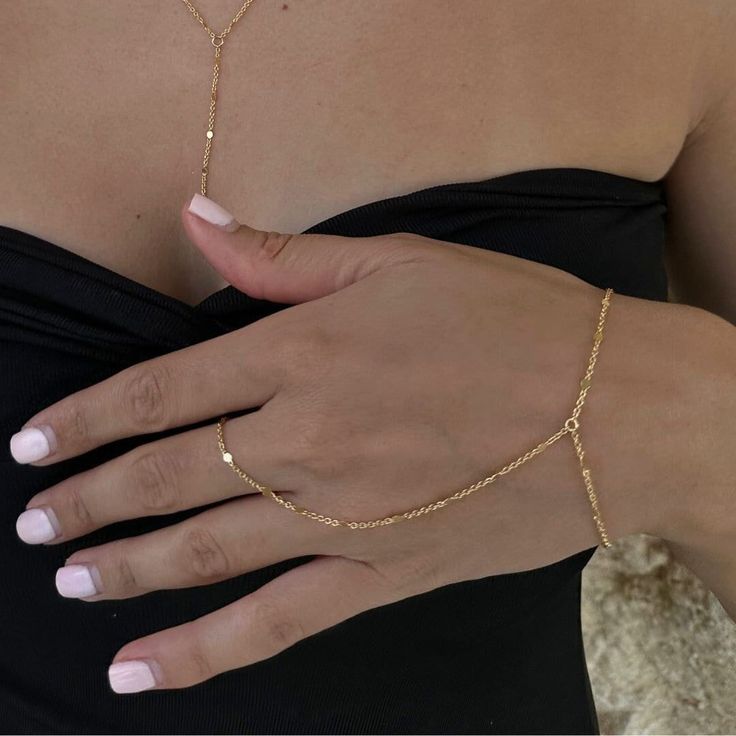 Dainty 18k gold plated/platinum plated hand chain. Our hand chain is so flattering and comfortable to wear. Our chain is sparkly and sits so beautifully on the hand. Layer with some of your favourite rings and bracelets. We have always been obsessed with hand chains so we created our own. Hand chains are so dainty and give that extra sparkle and shine to your hands. Measurements:  Bracelet - 6.5-7" inches (comes with extra adjustable 2" chain extender) Wrist to finger - 7 cm Please feel free to Finger Chain Bracelet, Permanent Hand Chain, Elegant Gold Chain Adjustable Ring, Elegant Adjustable Gold Chain Ring, Elegant Adjustable Chain Link Ring, Minimalist Delicate Chain Bracelet For Party, Minimalist Adjustable Gold Chain Ring, Minimalist Adjustable Chain Ring For Party, Minimalist Link Jewelry For Party