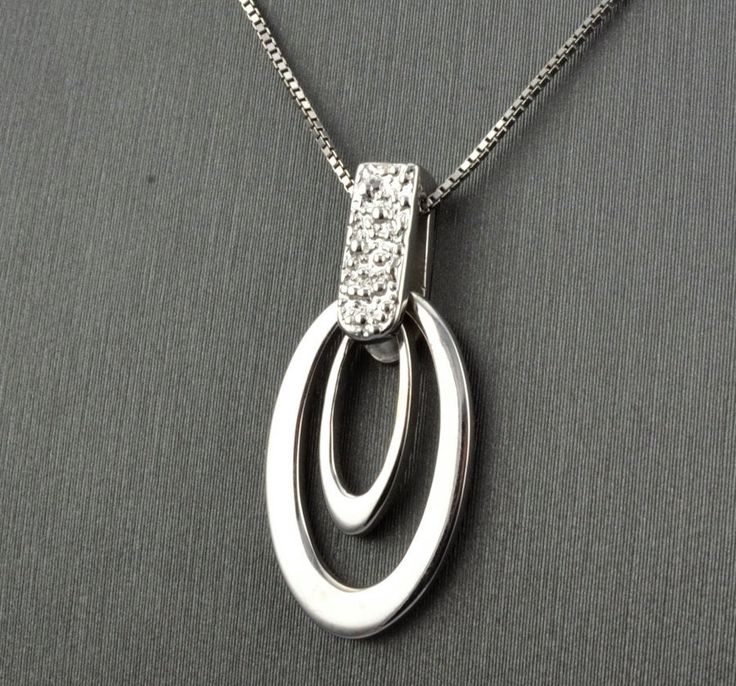 "14 KARAT WHITE GOLD MODERN PENDANT WITH HIGH POLISH . AVAILABLE SAME STYLE EARRINGS metal-14kwg weight-3.4gm FOR ADDITIONAL QUESTIONS ABOUT THIS PRODUCT: Please feel free to message us. We are quick to respond to all your inquiries. PLEASE choose as \"FAVORITE\" on the right so the item will be added to your favorites list and you may always revisit it. CUSTOM ORDERS: Please feel free to contact us if you could not find the piece you had in mind. We know how important it is to find the right je Modern White Gold Necklace With Diamond Accents, Fine Jewelry In White Gold With Shiny Finish, Modern Platinum Necklace As Gift, Modern Platinum Necklaces As Gift, Platinum Hallmarked Necklaces, Modern White Gold Diamond Necklace For Anniversary, White Gold Diamond Jewelry With Shiny Finish, White Gold Necklace With Oval Pendant For Anniversary, Modern Silver Diamond Cut Necklace