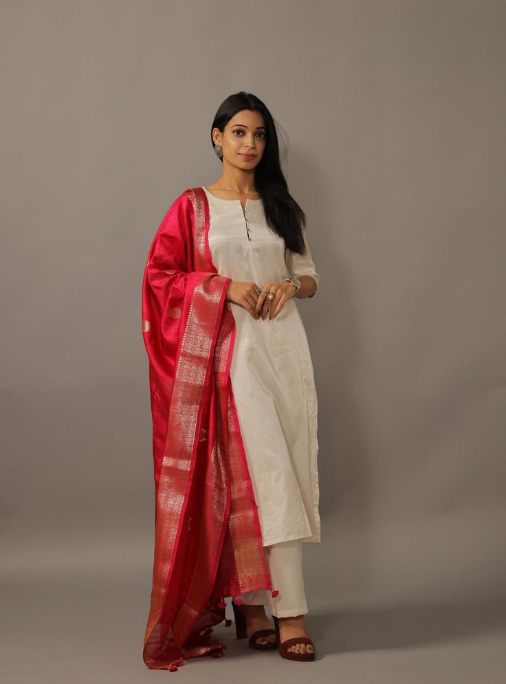 Important Instrucitons : We request you to kindly calculate the processing time of your order  after the mutual confirmation on Bespoke measurements between us has taken place (either via message , e mail or form) Rajanyas New Collection | Specially Crafted For Women | Material: Gajji Silk Color: Kurti Set: Off White, Dupatta: Margenta  Details: Silk Straight Kurti With Button Details on Split Neckline | Straight Pants | | Traditional Margenta  Banarasi Dupatta Package contents: 1 Kurti + 1 Pant White Kurta With Bandhani Dupatta, Elegant Churidar For Festive Traditional Ceremonies, Elegant Churidar For Traditional Ceremonies And Festive Occasions, Elegant Katan Silk Churidar For Festivals, Slub Silk Kurta With Dupatta For Puja, Elegant Katan Silk Churidar For Diwali, Raw Silk Set With Dupatta For Puja, Churidar For Diwali, Navratri Tussar Silk Churidar With Pallu