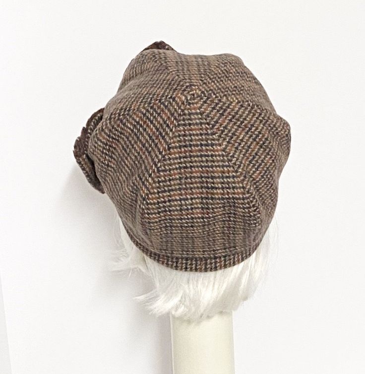 That Girl Beret hat multi color wool tweed, lined in printed rayon blend, the top of the hat is made up of 6 section crown, wool bias 1" fitted band and has a elastic band inside. One size fits most up to a 22" head size Made in the USA Dry clean only Fitted Wool Flat Cap, Adjustable Tweed Flat Cap, Classic Adjustable Tweed Hat, Fitted Tweed Cap, Classic Fitted Felt Cap, Classic Adjustable Cloche Hat Flat Cap, Adjustable Brimmed Wool Cloche Hat, Adjustable Wool Brimmed Cloche Hat, Wool Brimmed Beret For Fall