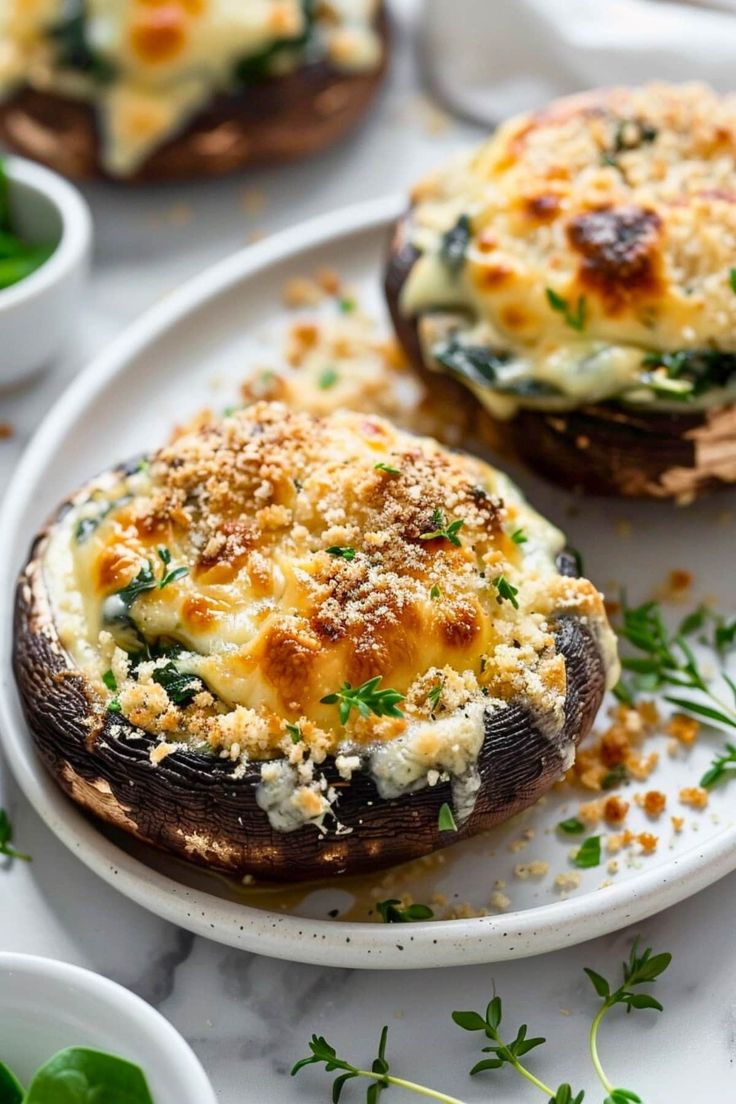 baked stuffed mushrooms with cheese and herbs on a white plate