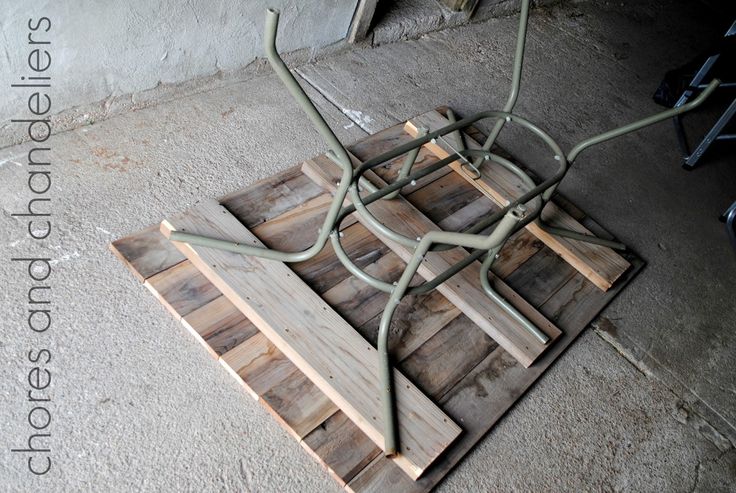 a piece of wood sitting on top of a sidewalk next to a building with wires attached to it