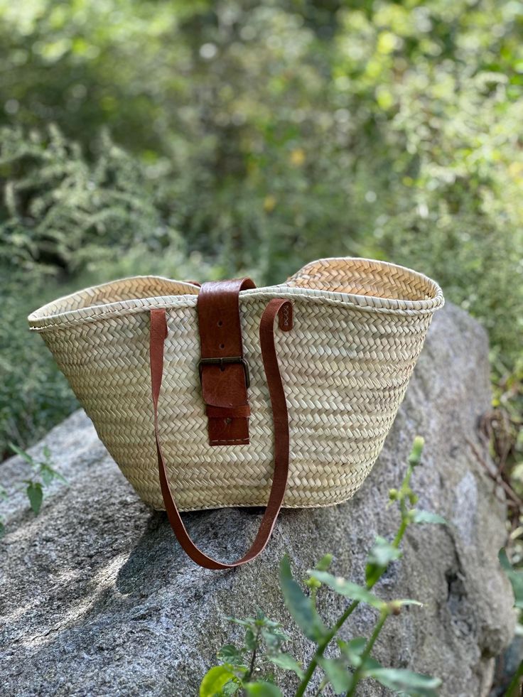 Elevate your style with this stunning natural Moroccan handmade straw bag. Expertly crafted by skilled artisans, this spacious bag combines functionality and elegance, making it perfect for everyday use or a day at the beach. The intricate weaving showcases traditional Moroccan craftsmanship, while the durable leather straps provide comfort and style. With its roomy interior, it effortlessly accommodates your essentials, from beach towels to groceries. Embrace the charm of Moroccan culture and make a sustainable fashion statement with this beautiful, eco-friendly accessory. Chic Straw Bag For Market, Natural Double Handle Braided Shoulder Bag, Natural Braided Shoulder Bag With Double Handle, Summer Woven Leather Market Bag, Summer Woven Leather Bags For Market, Natural Straw Bag With Double Handle For Market, Natural Double Handle Straw Bag For Market, Artisan Beige Straw Bag For Market, Natural Palm Leaf Bags With Braided Handles