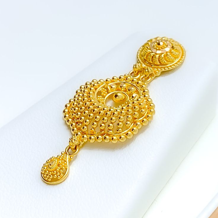 This 22k gold necklace set is a mesmerizing display of artistry, featuring intricate peacock feather accents that evoke elegance and grace. Weighing 32.0 grams, the set is crafted in radiant yellow gold with a 16-inch necklace, adjustable by 1.75-inch links, and secured with a hook lock. The matching earrings, 1.75 inches in length, include screw-back posts for secure and comfortable wear. The detailed peacock feather design adds a unique and luxurious touch, making this set ideal for those who appreciate sophisticated, nature-inspired jewelry, perfect for special occasions. PRODUCT DETAILS Gold Purity(karat): 22k Gold Weight(grams): 32.0 Item Finish: Yellow Gold Set Length: 16" Drop Length: 1.5" Adjustable Links: 1.75" Links Lock Style: Hook Lock Matching Earrings: Included Earring Length 22k Yellow Gold Chandbali Jewelry, 22k Gold Chandbali Jewelry In Yellow Gold, Elegant Ceremonial Necklaces With Peacock Design, Yellow Gold Jewelry With Peacock Design For Gift, Exquisite Gold Chandbali Jewelry, Ceremonial 22k Gold Filigree Jewelry, Gold-plated Jewelry With Peacock Design, Gold Plated Peacock Design Jewelry, Gold Jewelry Sets With Peacock Design