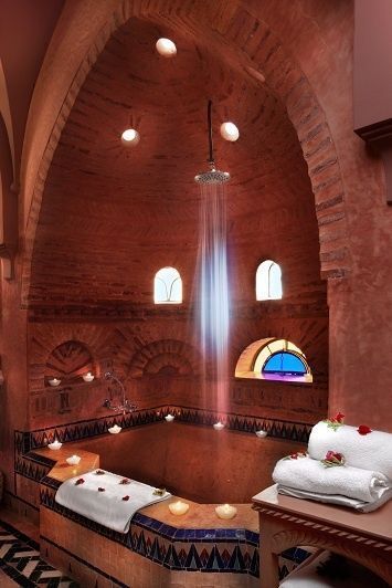 a large bath room with an arched ceiling and stained glass windows on the side wall