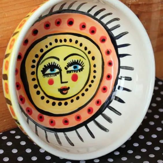 a bowl with a face painted on it