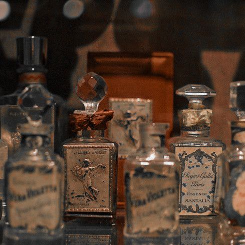 an assortment of perfume bottles sitting on top of a table