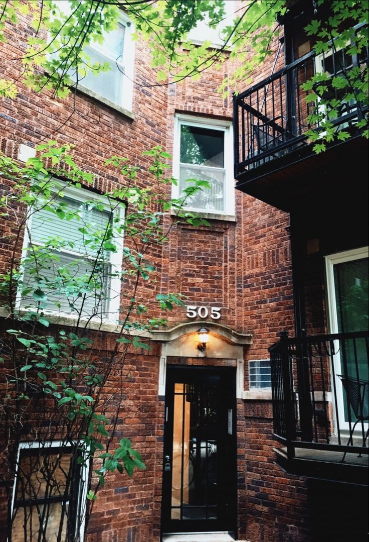 an apartment building with stairs leading up to the front door