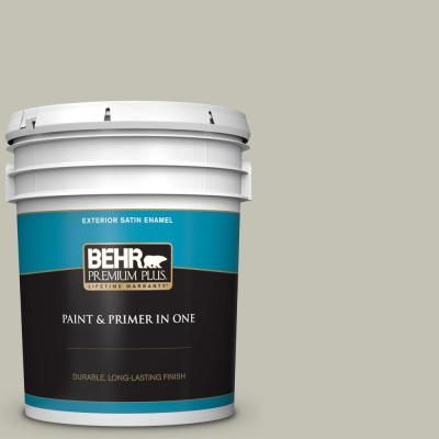 a bucket of behr paint and primer in one, on a blue background