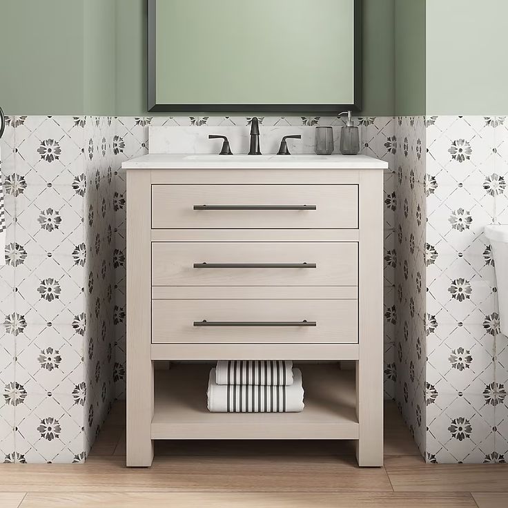 a white sink sitting under a mirror in a bathroom