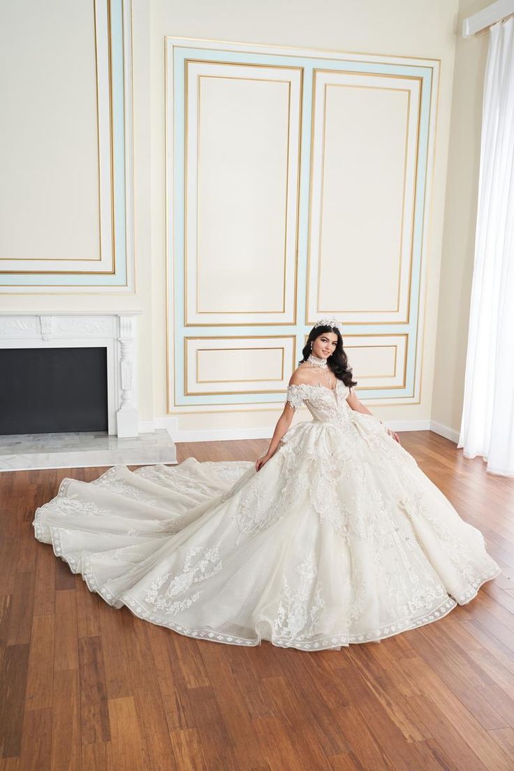 a woman in a wedding dress is posing for the camera