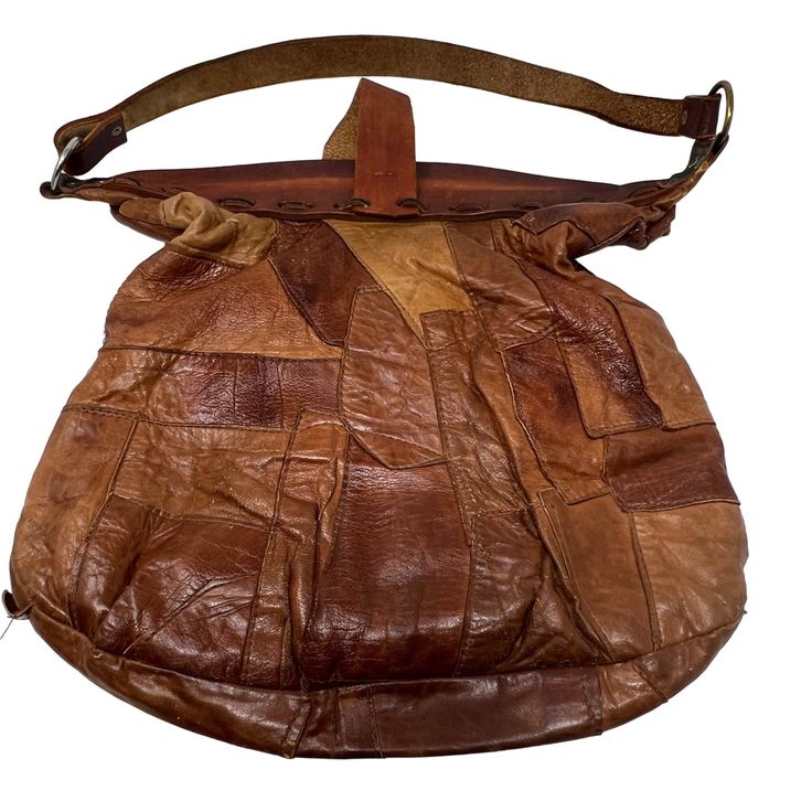 Patchwork Leather O-Ring Shoulder Bag Features: * Brown * Patchwork * Shoulder strap * O-ring detail * Silver tone hardware * Shoulder Bag * Unlined * Leather material Size: Womens OS Measurements: Height 14 in / 36 cm Width 14.5 in / 37 cm Condition: Pre-Owned Good Distressed- Unlined  ladies casual blouse Saturday Sunday travel vacation summer spring everyday patchwork leather boho hippie tote handbag weekend outfit Vintage Hobo Bag With Adjustable Strap For Travel, Vintage Crossbody Satchel With Handles, Brown Leather Satchel With Snap Closure, Vintage Leather Hobo Bag For Travel, Vintage Leather-backed Hobo Bag For Travel, Vintage Hobo Bag With Detachable Strap For Everyday, Vintage Hobo Bag With Leather Backing For Travel, Retro Leather Shoulder Bag With Snap Closure, Retro Brown Saddle Bag For Everyday