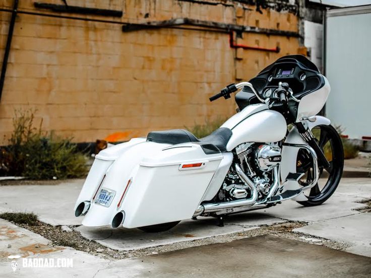 a white motorcycle parked in front of a building