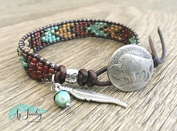 This Native American Style Seed Bead Leather Wrap Bracelet Is Handmade With Picasso Finished Seed Beads And The Finest Quality Rustic Leather, This Bracelet Is The Focal Point Of This Beaded Wrap Bracelet Southwestern Style Is The Indian Head Button Closure. I Have Added a Feather Charm To Complete Artisan Brown Wrap Bracelet With Round Beads, Spiritual Brown Leather Bracelet With Round Beads, Nickel-free Brown Spiritual Beaded Bracelets, Brown Nickel-free Spiritual Beaded Bracelets, Bohemian Brown Wrap Bracelet Nickel Free, Nickel Free Brown Wrap Bracelet As Gift, Nickel Free Brown Wrap Bracelet For Gift, Nickel-free Brown Wrap Bracelet As Gift, Nickel-free Brown Wrap Bracelet Gift