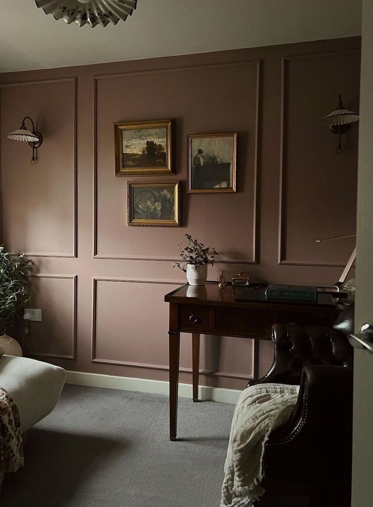 a living room filled with furniture and paintings on the wall