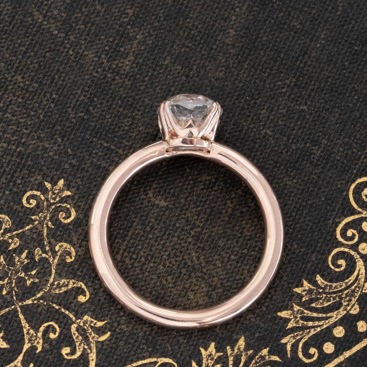 It doesn't get more classic than this! A sweet rose gold solitaire with a 1.51ct old mine cut diamond, a bright and shining GIA J color and VS2 clarity. The stone has very classic old mine faceting in an ever-so-slightly elongated, cushiony shape which we just adore. The rose gold leans into that antique gold which always has a touch of rosy color, with double claw prongs holding her together at the corners. 14kt rose gold Size 4.75 & resizable Diamond measures 7.26 x 6.62 x 4.36 mm GIA report l 14k Rose Gold Diamond Ring With Single Round Cut, Heirloom Rose Gold Diamond Ring With Single Diamond, Timeless Rose Gold Moissanite Wedding Ring, Rose Gold Solitaire Diamond Ring, Asscher Cut, 14k Rose Gold Brilliant Cut Diamond Ring, Heirloom Rose Gold Diamond Ring With Round Cut, Rose Gold Asscher Cut Solitaire Diamond Ring, Rose Gold Solitaire Diamond Wedding Ring, Timeless Single Diamond Rose Gold Wedding Ring