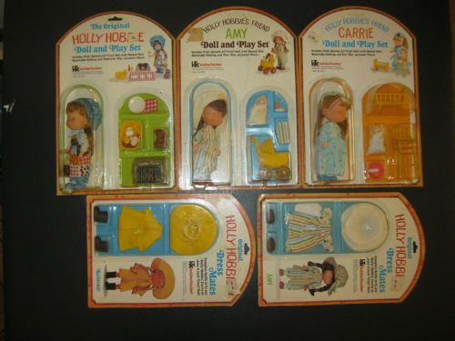 four plastic dollhouse toys are shown in the packagings for each child's play set