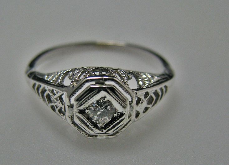 "For Sale: (1) H108 Gorgeous Diamond Ring in 14k White Gold from 1930's PLEASE READ ENTIRE DESCRIPTION BEFORE PURCHASING Please see pictures for more details! This stunning ring features a center 0.06 ct diamond. This is a beautiful filigree mounting down the side. The shank is decorated half way down. The ring is not stamped 14k, but was tested for it. This ring is from the 1930's. A beautiful piece for a any special occasion! What a great Gift! Specifics: *14k White Gold *Center Diamond approx Estate Style Diamond Cut Rings For Formal Occasions, Estate Style White Gold Diamond Ring For Formal Occasions, Vintage 14k White Gold Jewelry For Anniversary, Estate Jewelry With Diamond Cut For Formal Occasions, Vintage 14k White Gold Ring, Vintage 14k Stamped Filigree Ring For Formal Occasions, Vintage 14k White Gold Filigree Ring For Formal Occasions, Vintage 14k White Gold Jewelry, Vintage Diamond Cut Jewelry For Vintage Events