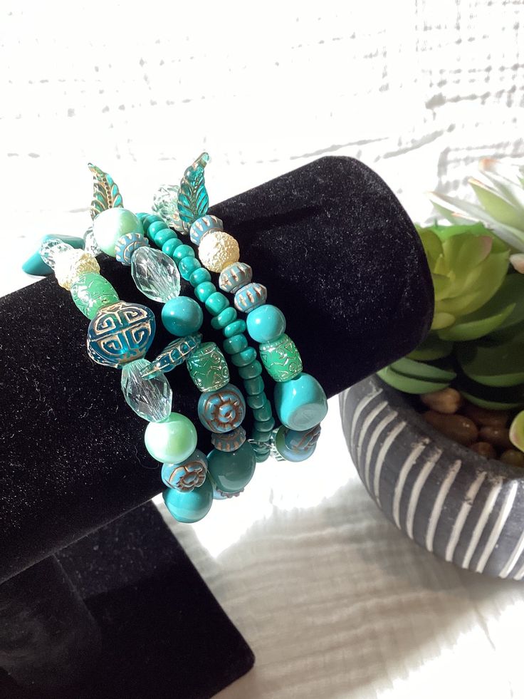 Blues and greens in a boho style stretchy band bracelet! Turquoise Beaded Bohemian Wrap Bracelet, Blue Bohemian Beaded Bracelets With Large Beads, Bohemian Blue Stretch Bracelet With Colorful Beads, Blue Bohemian Stretch Bracelet With Colorful Beads, Bohemian Blue Stretch Bracelet With Large Beads, Handmade Blue Bohemian Stretch Bracelet, Blue Bohemian Handmade Stretch Bracelet, Turquoise Stackable Bracelets For Festivals, Green Bohemian Wrap Bracelet For Festival