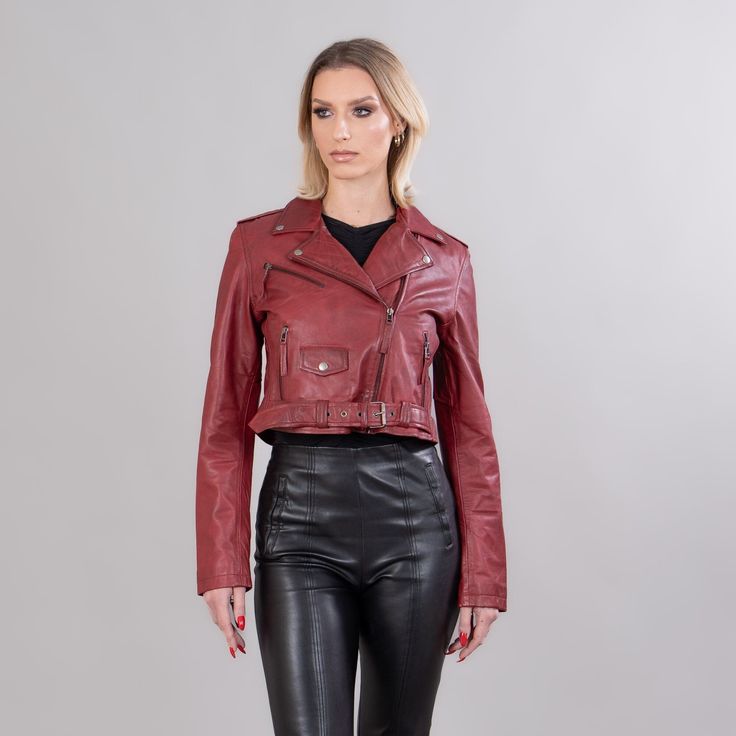 Burgundy short leather jacket.  This short jacket has zipped exterior side pockets, a collar, a belt, and also a zipper closure.  The garment will stand out with its unique pattern and warmth.  The jacket manufactures in our company in Greece with high-quality lambskin. Leather: Lamb Color: Red Length: 45-50 cm (17,7-19,6 in) Collar: Yes Exterior pockets: Yes Belt: Yes Lining: 100% Polyester Care: Specialist clean Edgy Leather Cropped Jacket With Long Sleeves, Cropped Leather Biker Jacket With Zipper, Leather Cropped Biker Jacket For Fall, Fall Cropped Leather Biker Jacket, Cropped Leather Biker Jacket For Fall, Trendy Cropped Leather Biker Jacket, Belted Leather Biker Jacket For Fall, Fall Leather Belted Biker Jacket, Leather Belted Biker Jacket For Fall