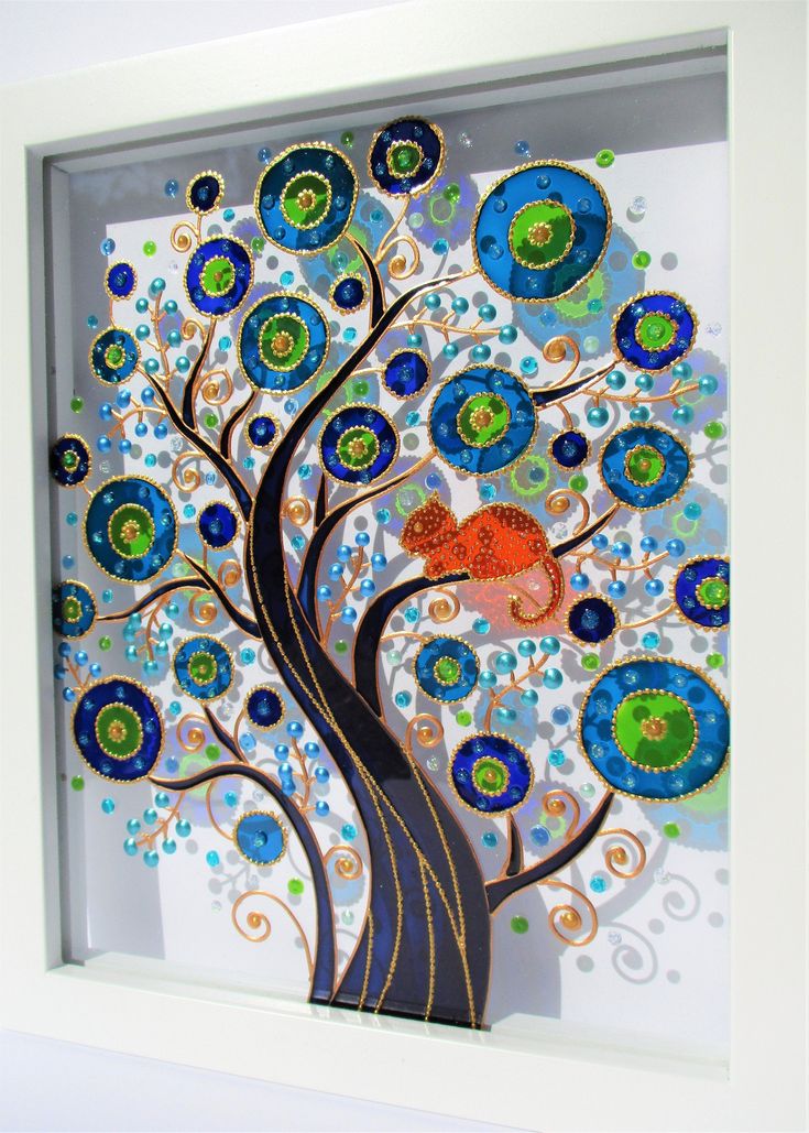 a tree with blue, green and orange circles on it is in a white frame